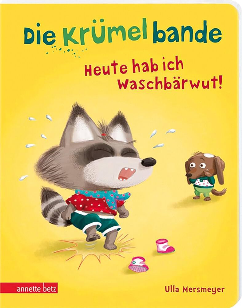 Titel des Buches Die Krümelbande – Heute hab ich Waschbärwut, Illustration eines wütenden Waschbären, daneben steht ein kleiner Hund und wunder sich, Hintergund: gelber Fond